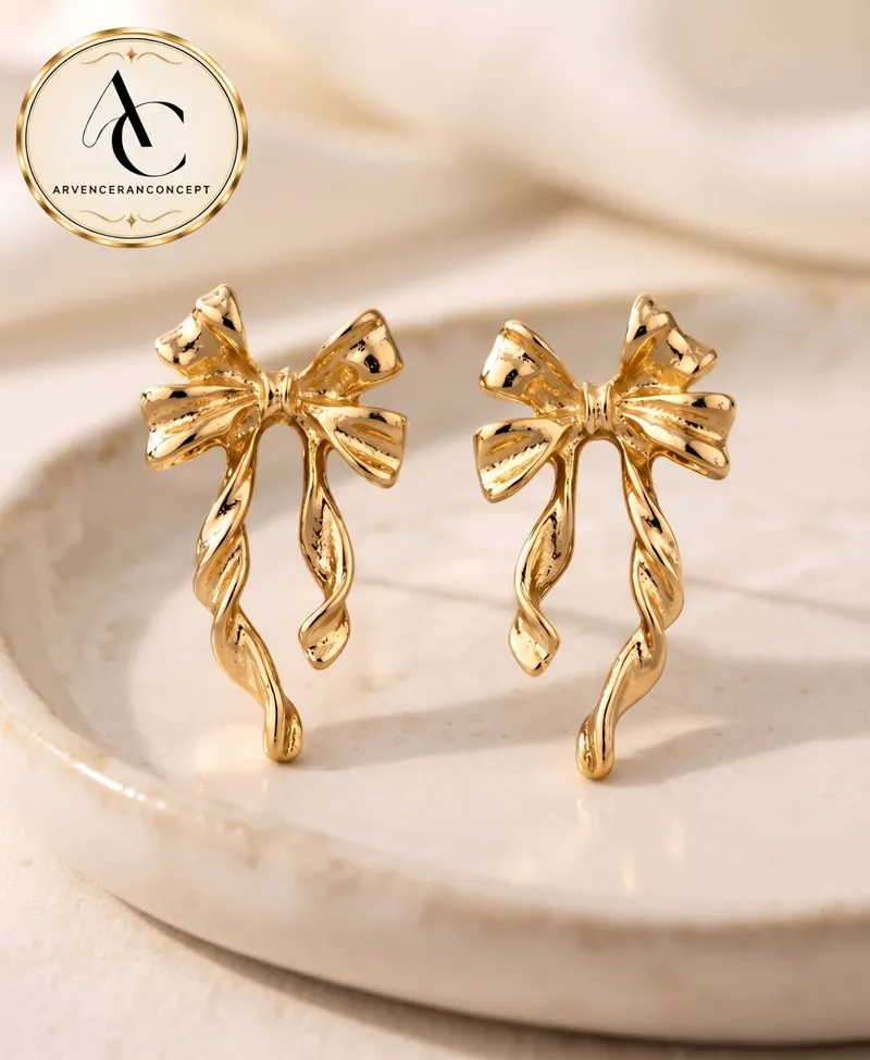 gold renk fiyonk motifli trend küpe